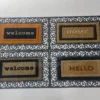 205828209_MTI4MC05NTktNGY5NDVhYzUxYQ Hello Door Mat with decorative border