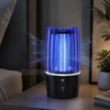 Electric Shock Mosquito Lamp Electric Shock Mosquito Lamp glowing blue on bedside table