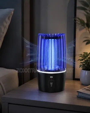 Electric Shock Mosquito Lamp glowing blue on bedside table