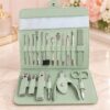 Pedicure manicure grooming set arranged inside compact green case Pedicure manicure grooming set arranged inside compact green case