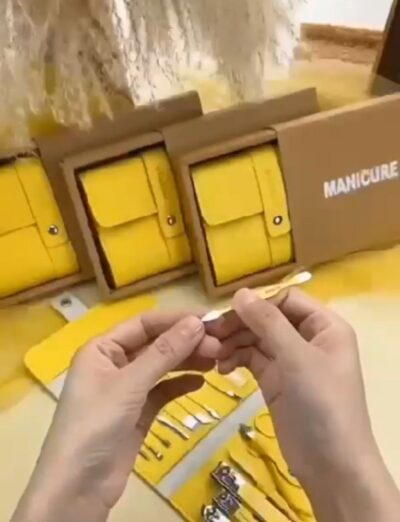 Pedicure manicure grooming set arranged inside compact yellow case Pedicure manicure grooming set arranged inside compact yellow case