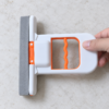 Compact white and orange sponge mop-2 Mini self-squeezing sponge mop being used to remove water from countertop