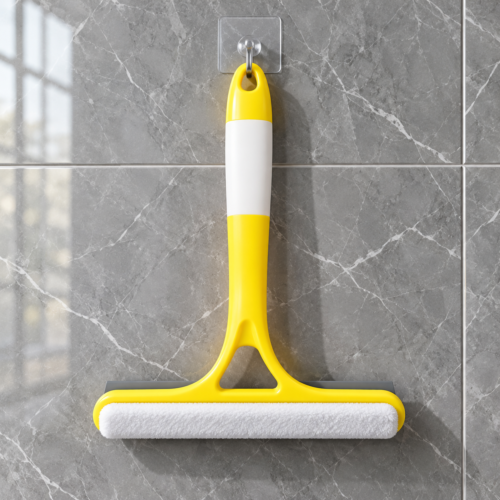 Yellow 2-in-1 window cleaner and squeegee hanging on tiled wall